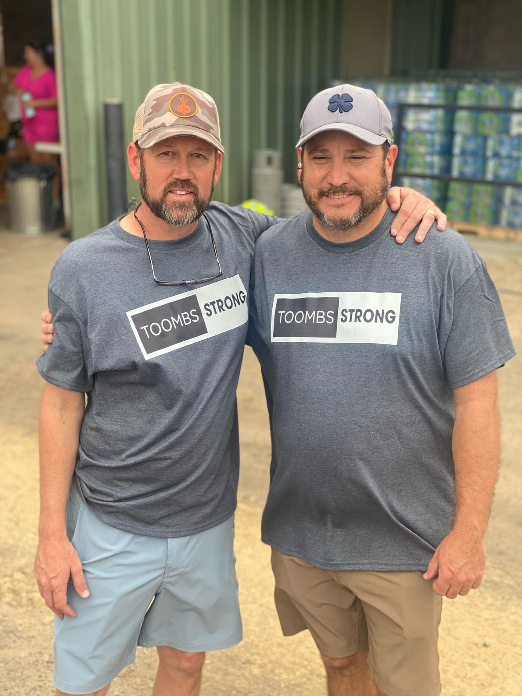 Two men wearing Toombs Strong t-shirts